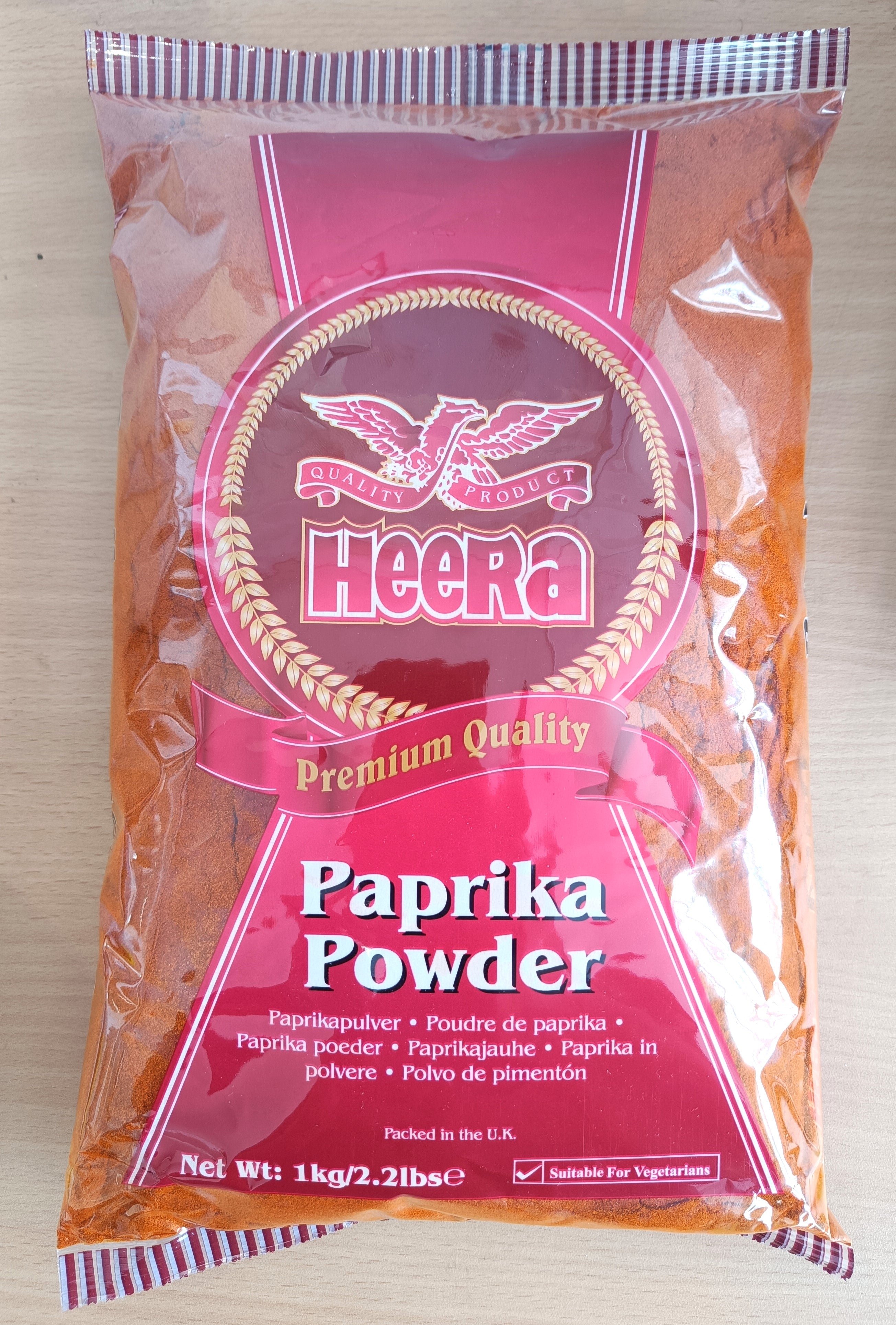 Heera paprika powder in a 1kg and 5kg bulk packaging, ground spice for culinary use, vibrant red ground paprika spice in a jar.