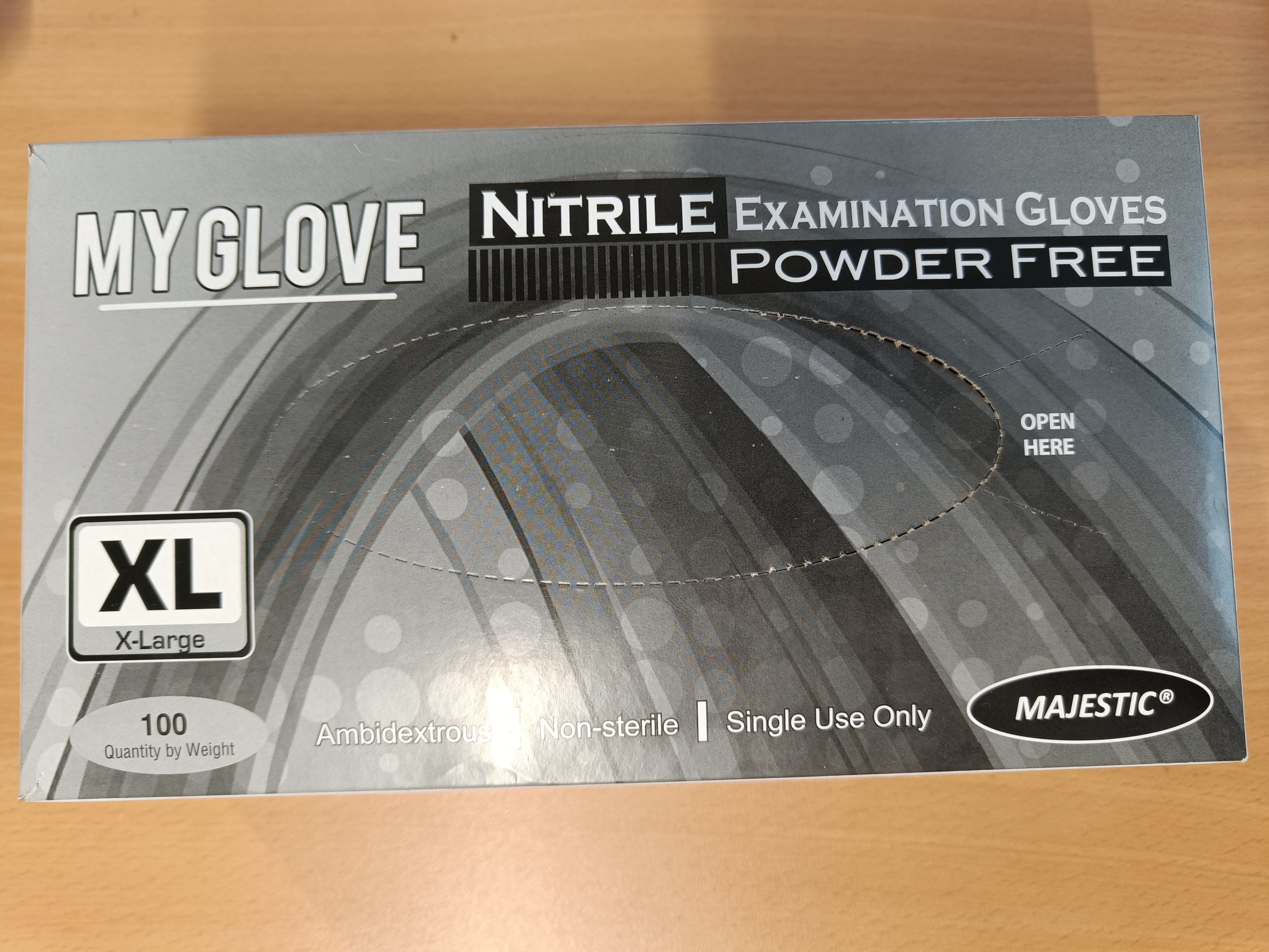Pair of black nitrile disposable gloves from Reign Goods, powder-free, latex-free, food-safe catering gloves in large and extra-large sizes.