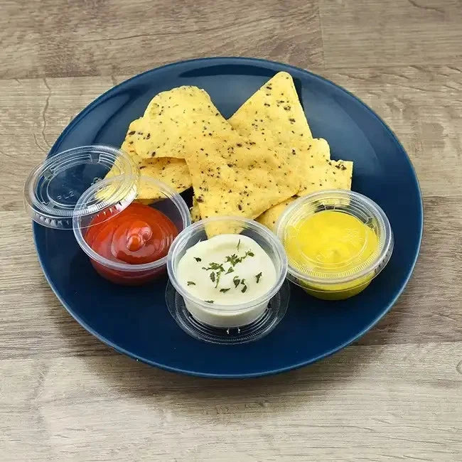 Set of five clear plastic round sauce pots with lids, 2oz / 60ml capacity, BPA-free, microwave and freezer safe by Reign Goods.
