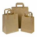 Large brown Kraft paper bags with handles, recyclable takeaway carrier bags from Reign Goods, eco-friendly packaging for food and retail.